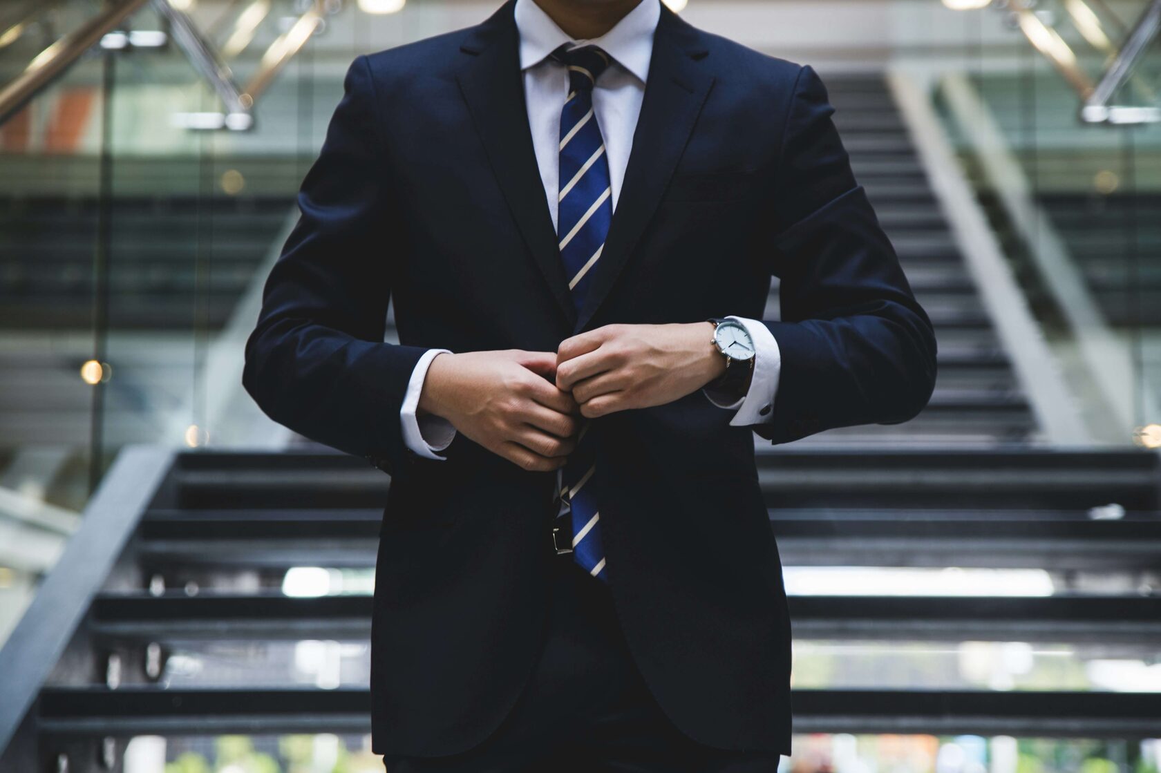 Business executive buttoning his jacket